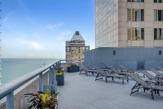 wooden terrace featuring a water view