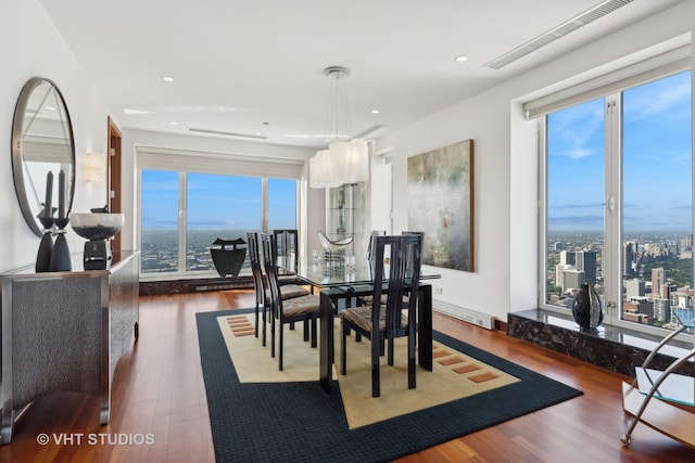 dining space featuring visible vents, wood finished floors, and recessed lighting