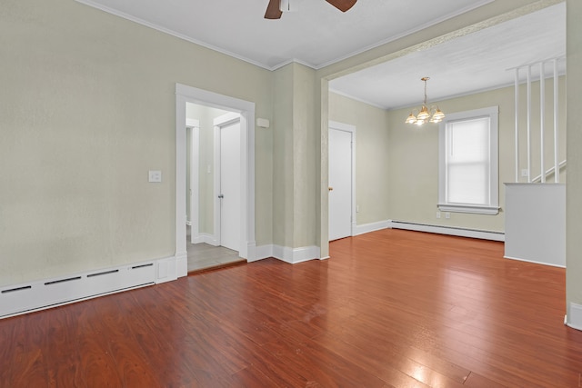 spare room featuring ceiling fan with notable chandelier, crown molding, baseboard heating, and wood-type flooring