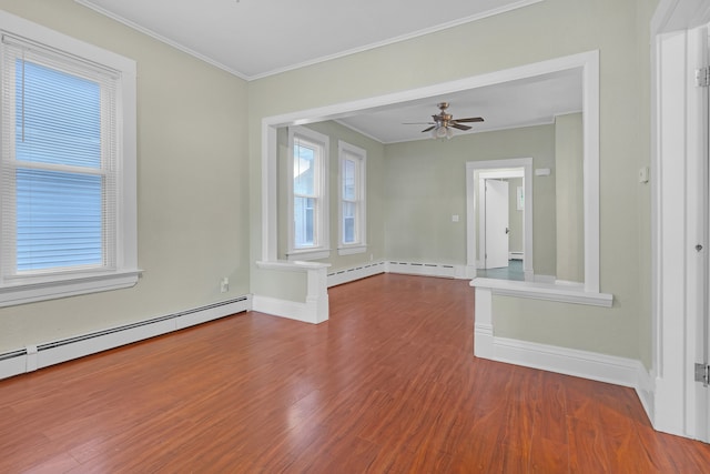 unfurnished room featuring a baseboard heating unit, ceiling fan, wood-type flooring, and ornamental molding