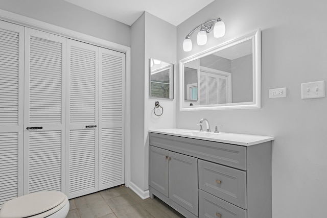 bathroom featuring vanity, toilet, and hardwood / wood-style flooring