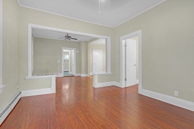 empty room with hardwood / wood-style floors, ceiling fan, baseboard heating, and crown molding