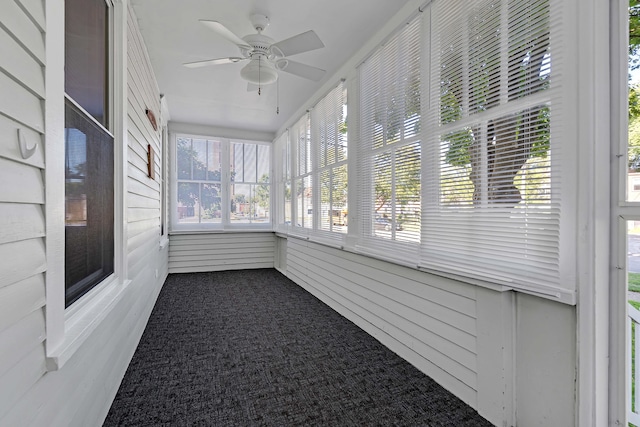 unfurnished sunroom with ceiling fan and a healthy amount of sunlight