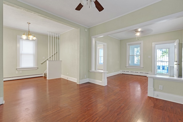 interior space with plenty of natural light, dark wood-type flooring, ceiling fan with notable chandelier, and a baseboard radiator