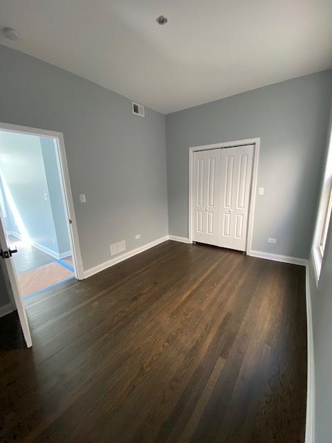 spare room featuring dark wood-type flooring