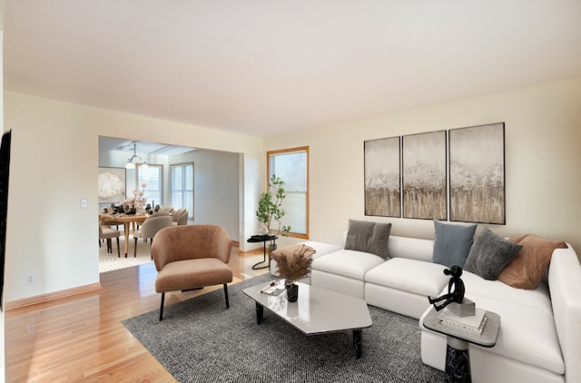 living room with baseboards and light wood-style floors