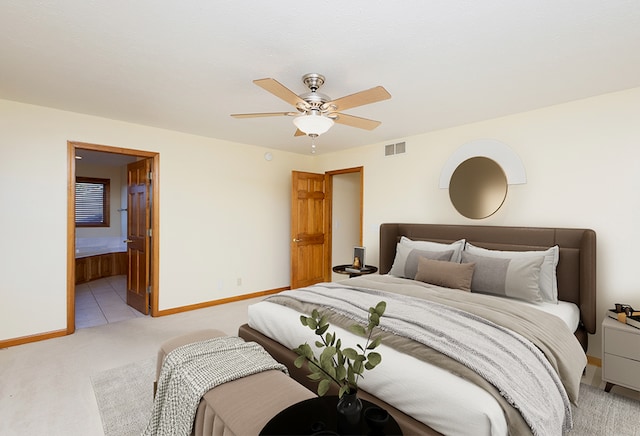 bedroom with a ceiling fan, baseboards, visible vents, light carpet, and connected bathroom