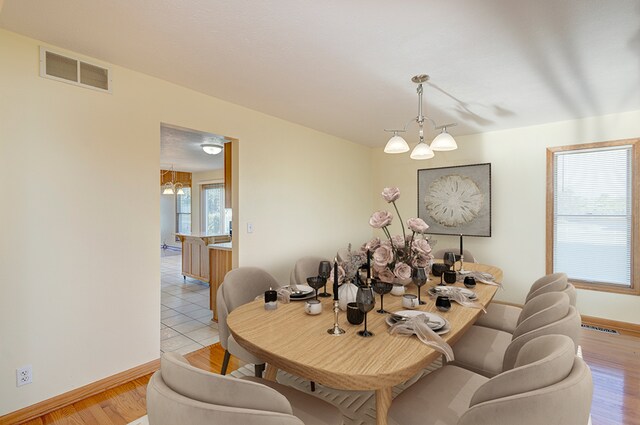 dining room featuring a chandelier and light hardwood / wood-style floors