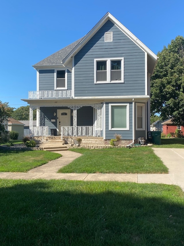 view of front of home with a front yard and a porch