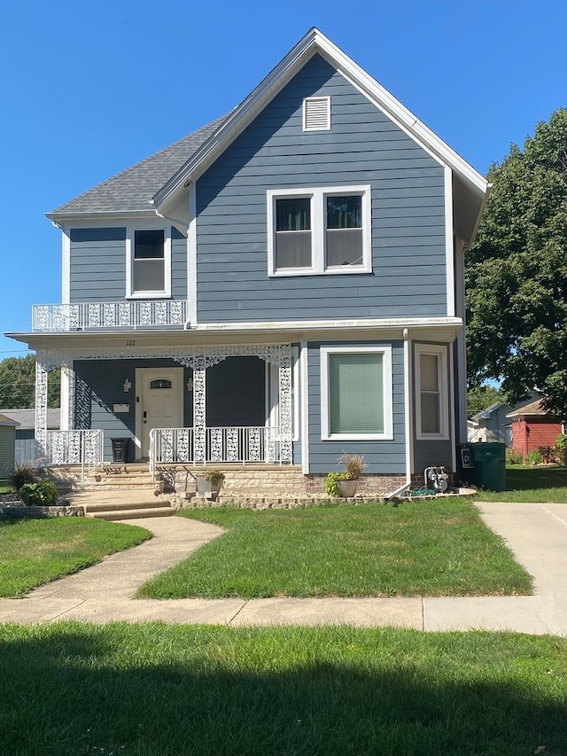 view of front of home with a front lawn and covered porch