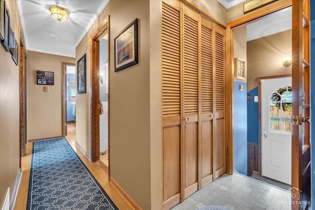 hall featuring baseboards and ornamental molding