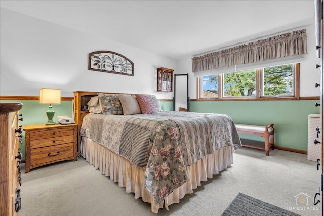 bedroom featuring carpet floors and baseboards