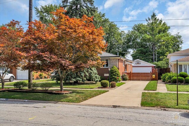 view of property hidden behind natural elements with a garage and a front lawn