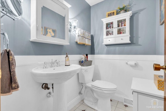 bathroom featuring toilet, tile patterned flooring, and visible vents