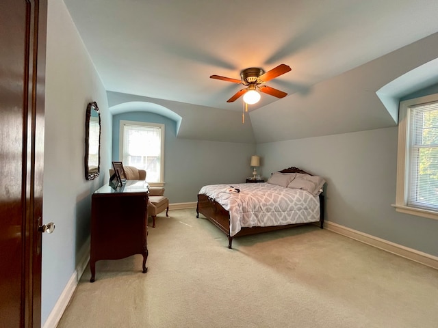 carpeted bedroom with ceiling fan, lofted ceiling, and multiple windows