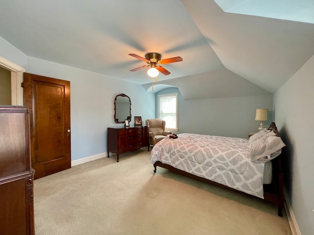 carpeted bedroom with ceiling fan and vaulted ceiling