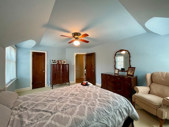 carpeted bedroom featuring vaulted ceiling and ceiling fan