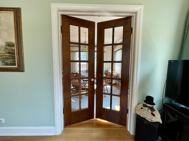 doorway featuring french doors, plenty of natural light, and hardwood / wood-style floors