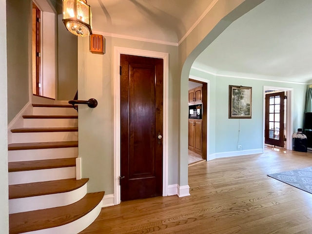 interior space featuring crown molding and wood-type flooring