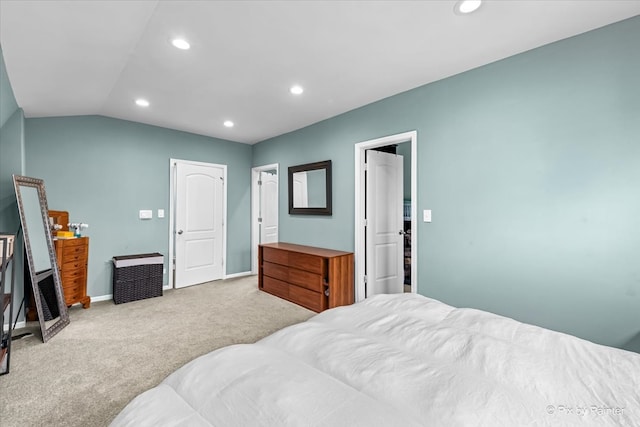 bedroom featuring light carpet and vaulted ceiling