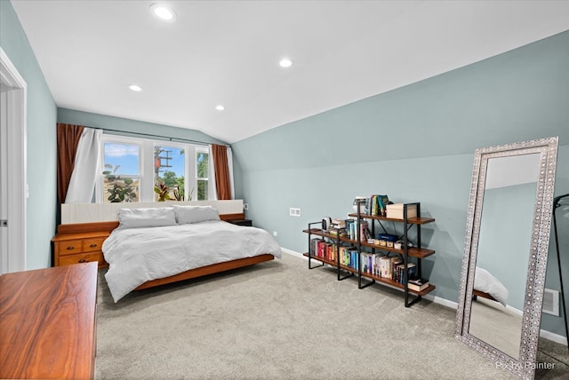 bedroom featuring lofted ceiling and light carpet