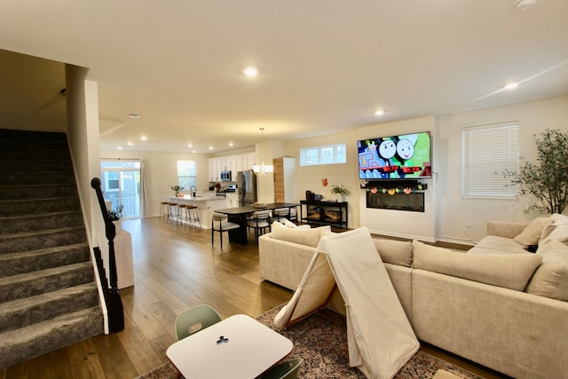 living room with a wealth of natural light and hardwood / wood-style flooring