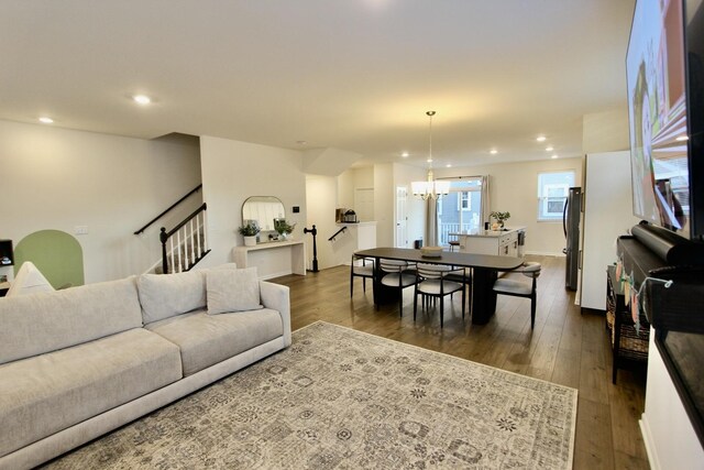 living room with a chandelier and dark hardwood / wood-style floors