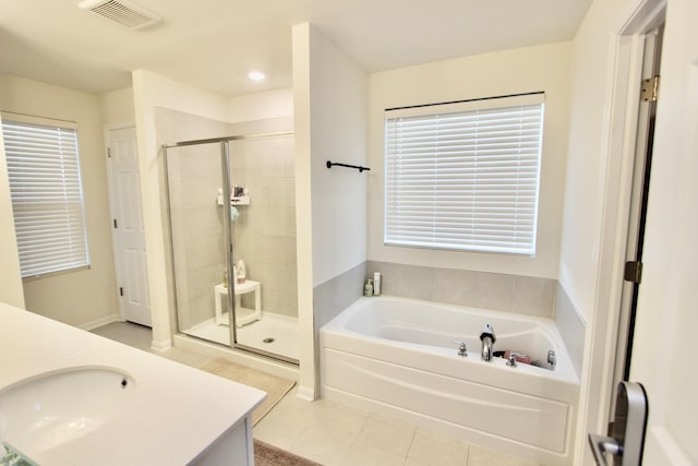 bathroom featuring tile patterned flooring, shower with separate bathtub, and vanity