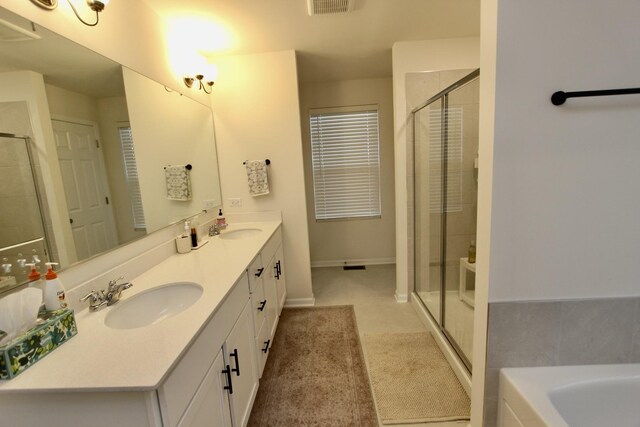 bathroom featuring shower with separate bathtub and vanity