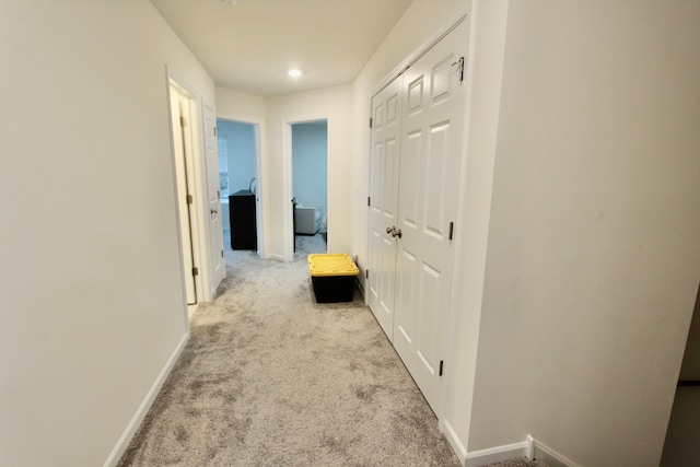 hallway with light colored carpet