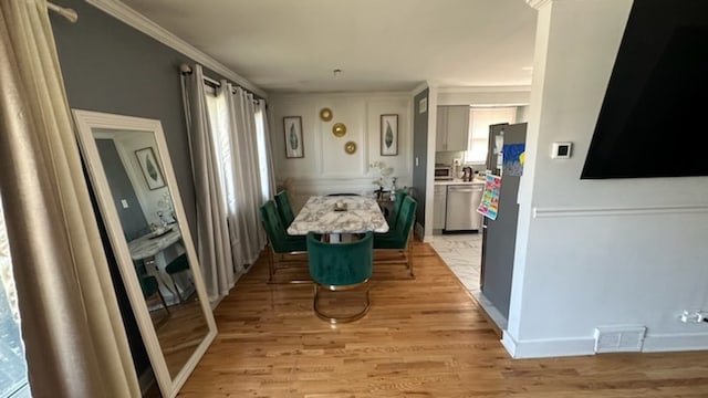 interior space featuring light wood-type flooring and crown molding