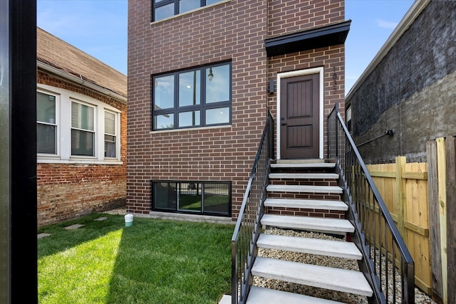 entrance to property featuring a yard