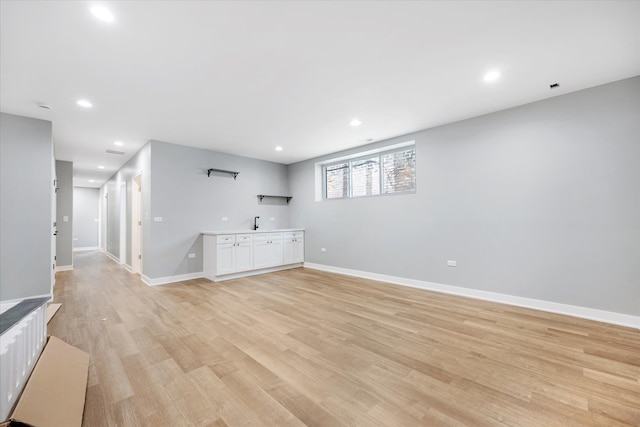 interior space with light hardwood / wood-style floors and sink