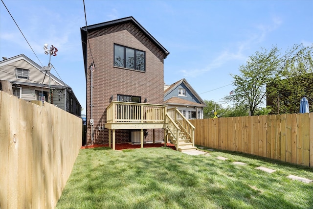 back of house with a lawn and a wooden deck