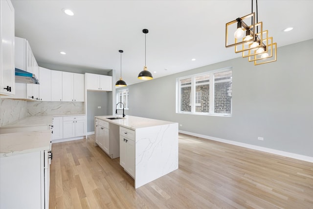 kitchen featuring white cabinetry, decorative light fixtures, and decorative backsplash