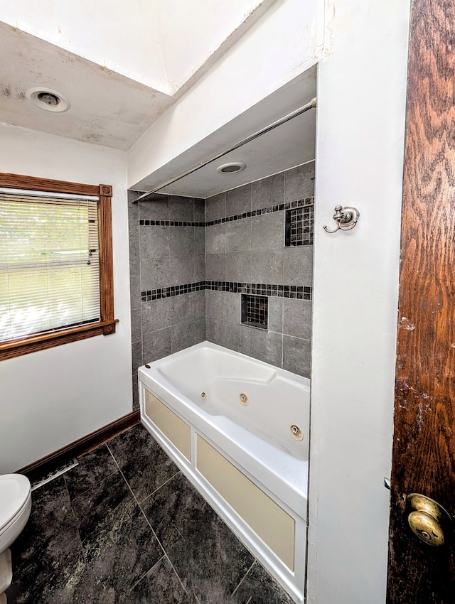 bathroom featuring toilet and a bathing tub