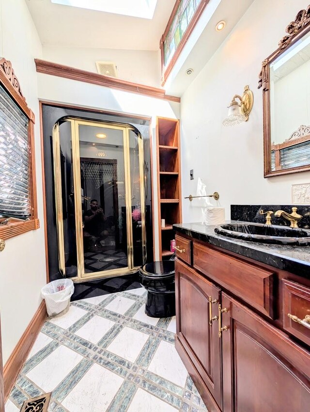 bathroom featuring lofted ceiling, vanity, and toilet