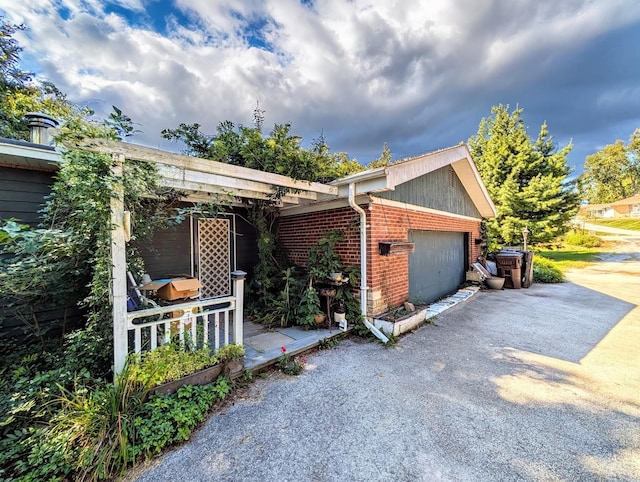 view of front of home with brick siding, aphalt driveway, and a garage