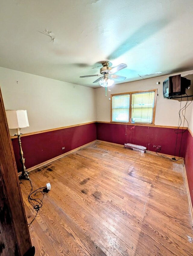 unfurnished room featuring hardwood / wood-style flooring and ceiling fan