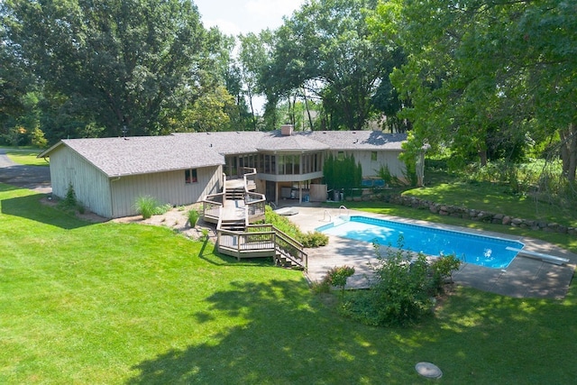 exterior space featuring a pool side deck, a patio area, and a lawn