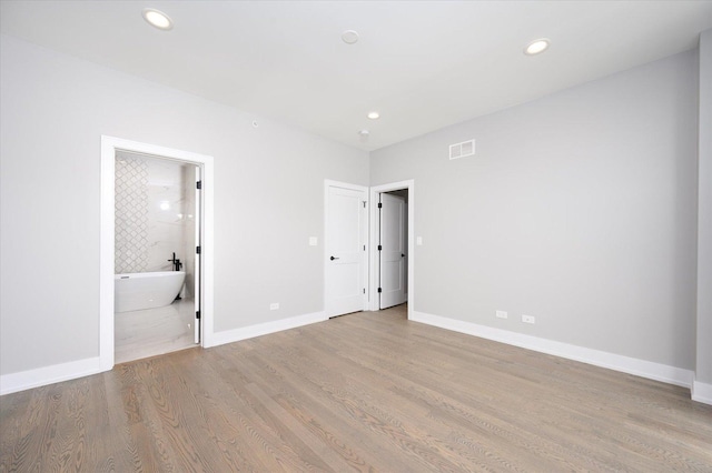 unfurnished bedroom featuring recessed lighting, baseboards, and wood finished floors