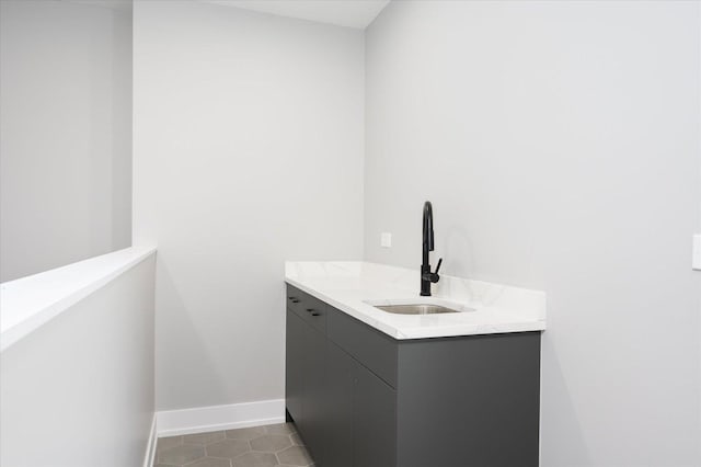 bathroom with tile patterned flooring, vanity, and baseboards