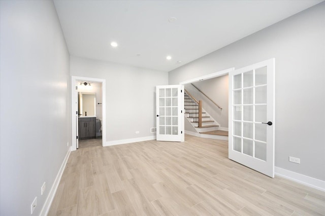 spare room with light wood-style flooring, recessed lighting, baseboards, stairs, and french doors