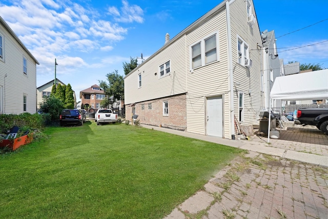 back of property featuring brick siding, a residential view, and a yard