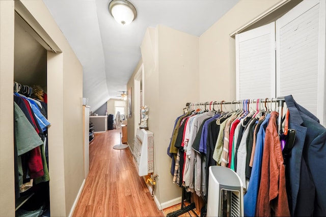 walk in closet featuring ceiling fan, lofted ceiling, and wood finished floors