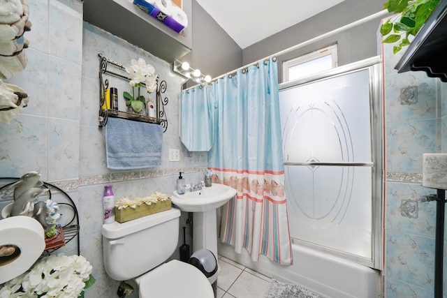 full bathroom featuring toilet, tile walls, bath / shower combo with glass door, and tile patterned flooring