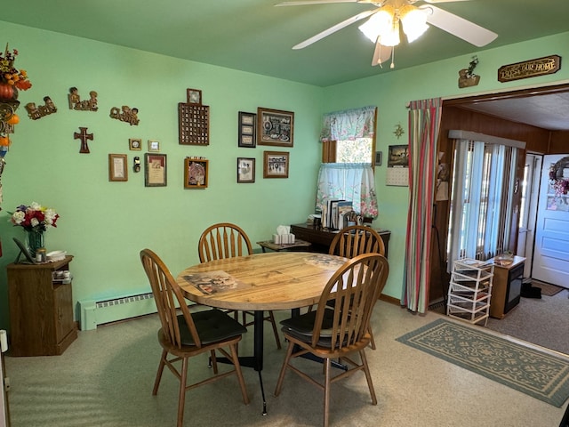 carpeted dining room featuring ceiling fan and a baseboard radiator