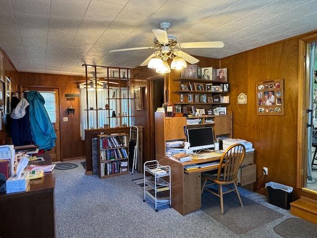 office area featuring ceiling fan, carpet floors, and wooden walls