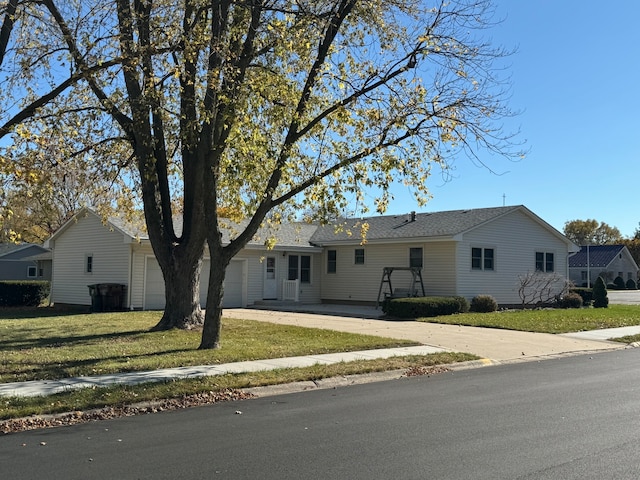 single story home with a garage and a front lawn