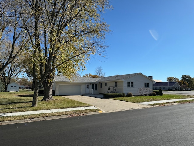 ranch-style house with a garage and a front lawn